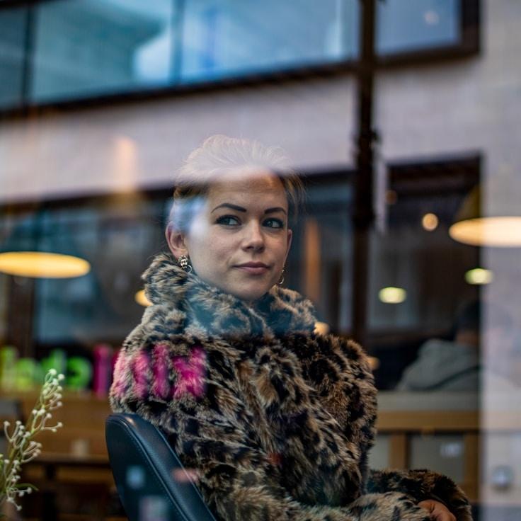 Kaveri Mehta, Lead Design Curator at GreenFieldSector, reviewing corporate floral arrangements